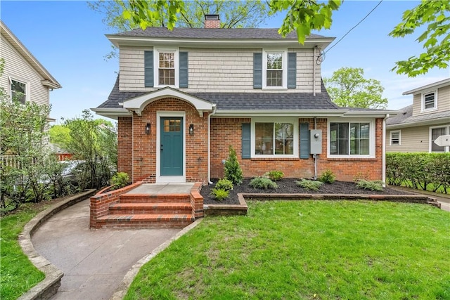 traditional-style home featuring a shingled roof, brick siding, a chimney, and a front yard