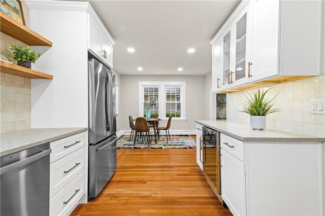 kitchen featuring light wood-style flooring, stainless steel appliances, white cabinetry, wine cooler, and recessed lighting