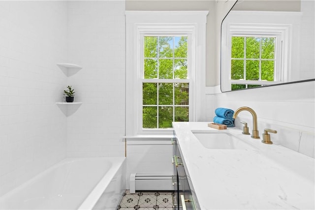 bathroom featuring baseboard heating, vanity, and plenty of natural light