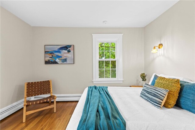 bedroom with baseboards and wood finished floors