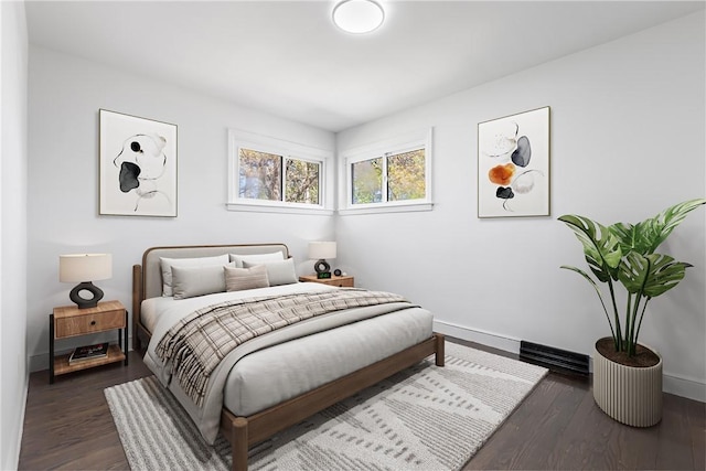 bedroom with baseboards and wood finished floors