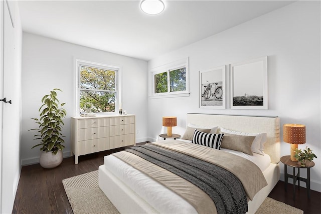 bedroom with baseboards and dark wood finished floors
