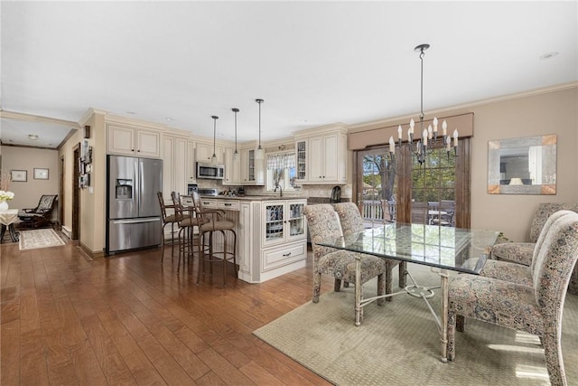 11 Renfrew Ave, Middletown, RI 02842 - dining room featuring ornamental molding, a chandelier, and dark wood-style flooring