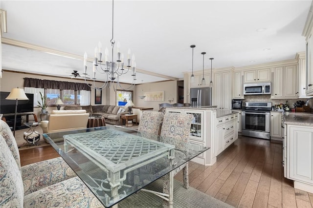 11 Renfrew Ave, Middletown, RI 02842 - dining room featuring dark wood finished floors, ornamental molding, a chandelier, and ceiling fan