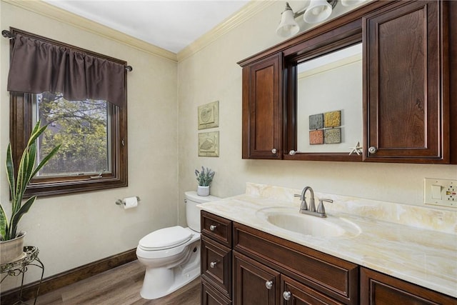 11 Renfrew Ave, Middletown, RI 02842 - bathroom with wood finished floors, toilet, vanity, baseboards, and crown molding