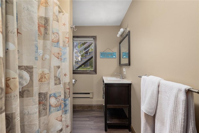 11 Renfrew Ave, Middletown, RI 02842 - full bathroom featuring wood finished floors, a baseboard radiator, vanity, baseboards, and a shower with shower curtain