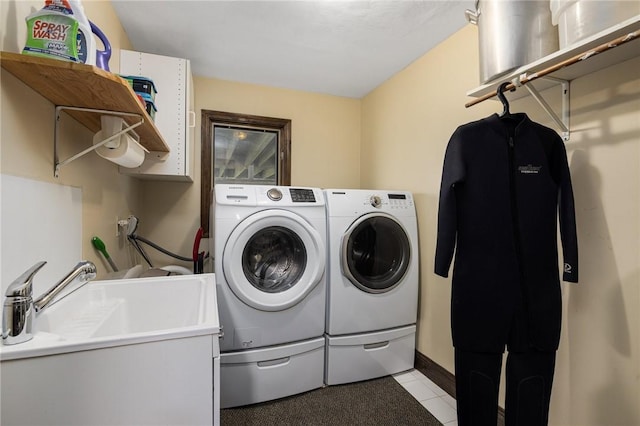 11 Renfrew Ave, Middletown, RI 02842 - laundry area featuring washer and dryer, light tile patterned flooring, and baseboards