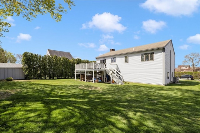 11 Renfrew Ave, Middletown, RI 02842 - back of house featuring stairs, central AC unit, a wooden deck, a chimney, and a lawn