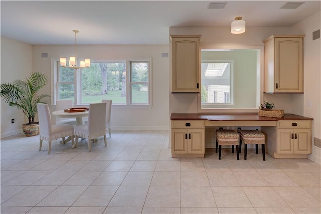 23 Pine Top Rd, Barrington, RI 02806 - kitchen with cream cabinets, a chandelier, dark countertops, and plenty of natural light