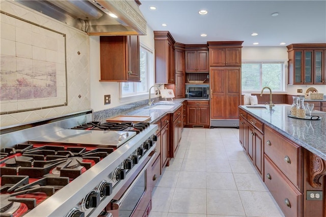 23 Pine Top Rd, Barrington, RI 02806 - kitchen with stainless steel appliances, ventilation hood, light stone counters, recessed lighting, and glass insert cabinets