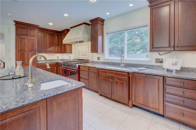 23 Pine Top Rd, Barrington, RI 02806 - kitchen with range with two ovens, premium range hood, light stone counters, recessed lighting, and light tile patterned flooring