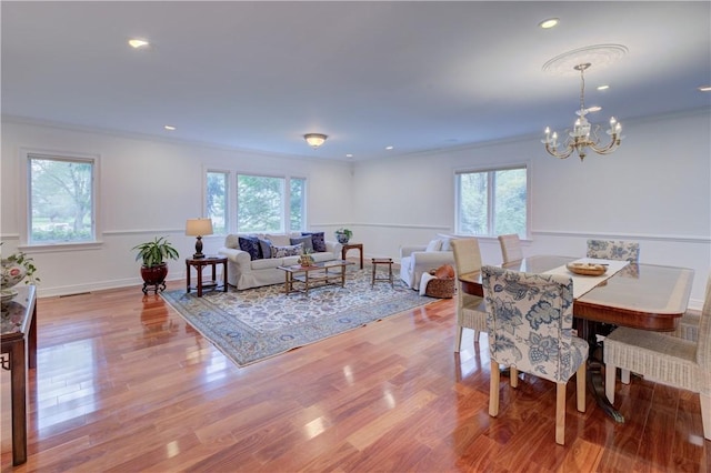 23 Pine Top Rd, Barrington, RI 02806 - dining room with healthy amount of natural light, a chandelier, ornamental molding, wood finished floors, and recessed lighting