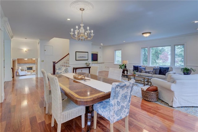 23 Pine Top Rd, Barrington, RI 02806 - dining area featuring stairs, a chandelier, crown molding, wood finished floors, and recessed lighting