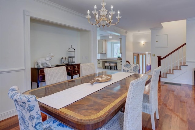 23 Pine Top Rd, Barrington, RI 02806 - dining space with a chandelier, wood finished floors, ornamental molding, and stairway