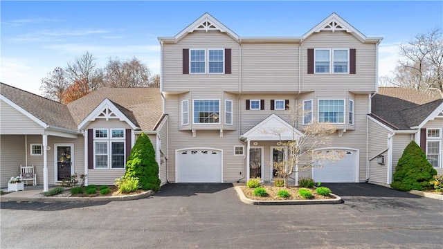 view of front of home featuring an attached garage and aphalt driveway