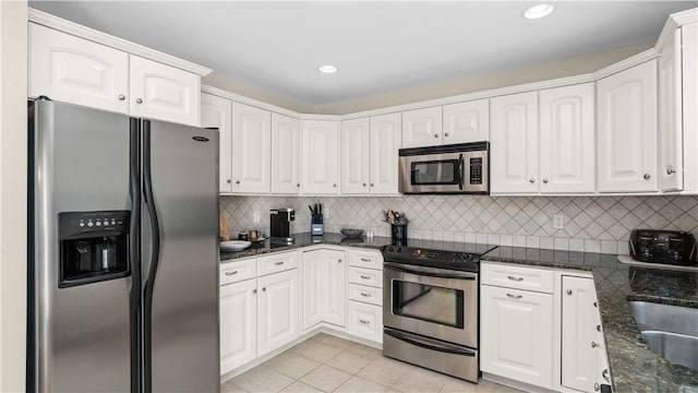 kitchen featuring stainless steel appliances, tasteful backsplash, and white cabinets