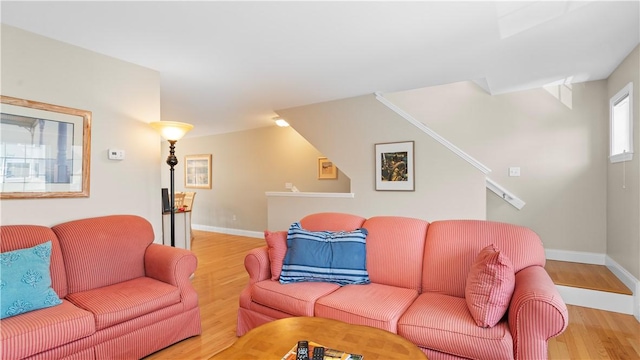 living area featuring light wood finished floors and baseboards