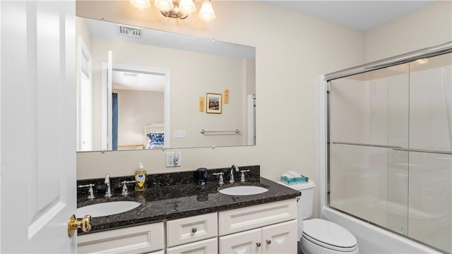 bathroom with a sink, double vanity, toilet, and visible vents
