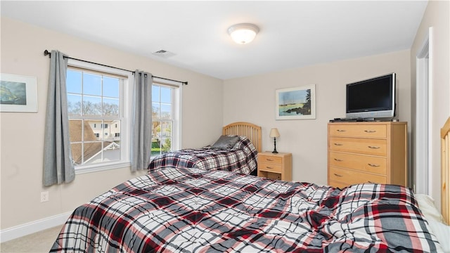 carpeted bedroom with baseboards and visible vents