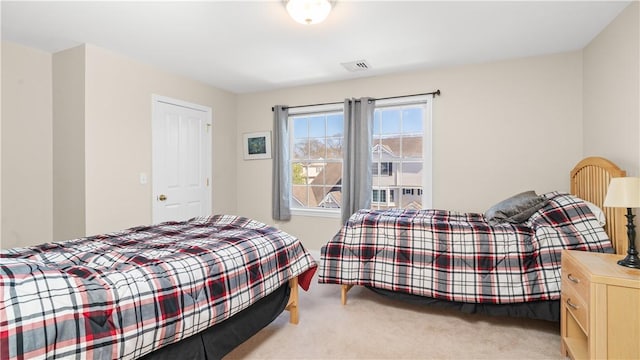 bedroom with carpet floors and visible vents