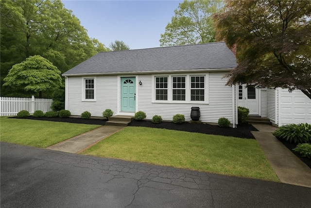 39 Whipple Rd, Smithfield, RI 02917 - view of front of house featuring fence, entry steps, roof with shingles, and a front yard