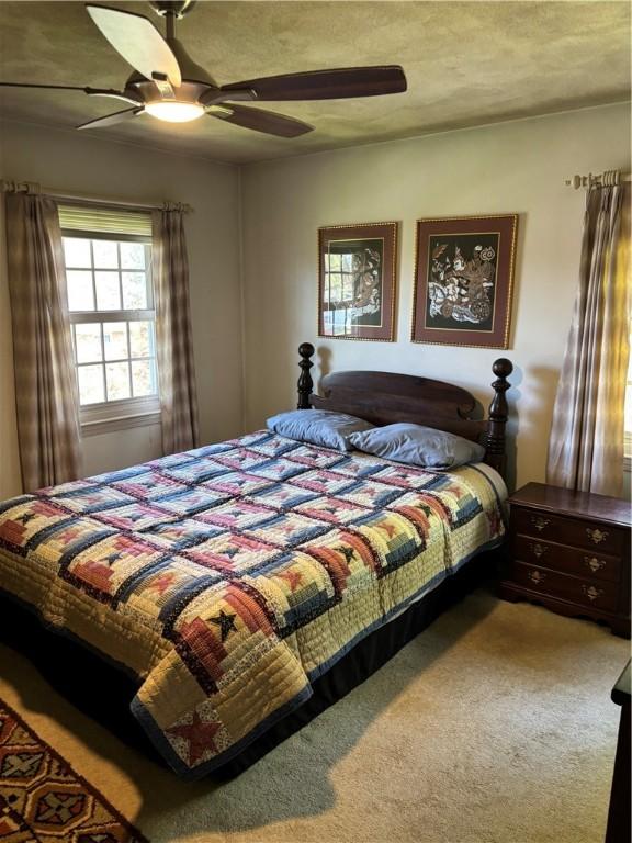bedroom with carpet floors and a ceiling fan