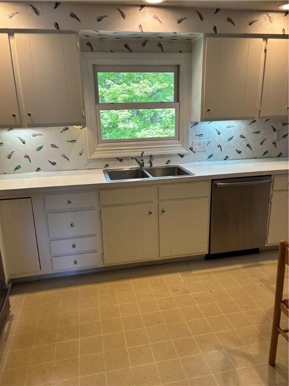 kitchen featuring a sink, light countertops, tasteful backsplash, and stainless steel dishwasher