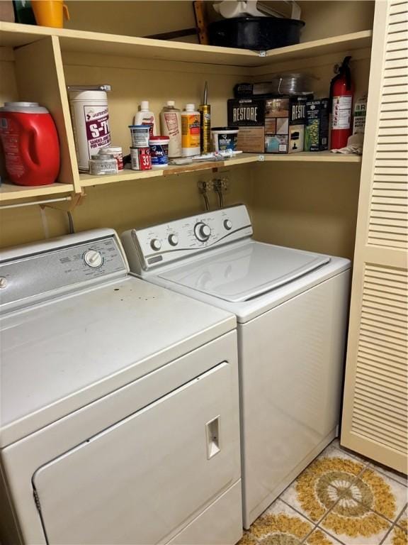 laundry area with separate washer and dryer, laundry area, and light tile patterned flooring