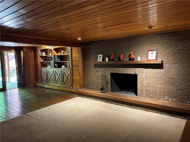 unfurnished living room featuring wood ceiling, wood walls, baseboard heating, and a fireplace