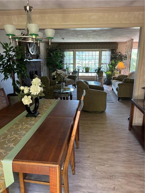 dining area with wood finished floors and a fireplace