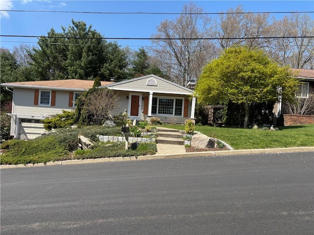 view of front of home featuring an attached garage and covered porch
