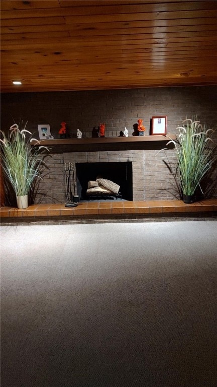 interior space with wooden ceiling, carpet, and a fireplace