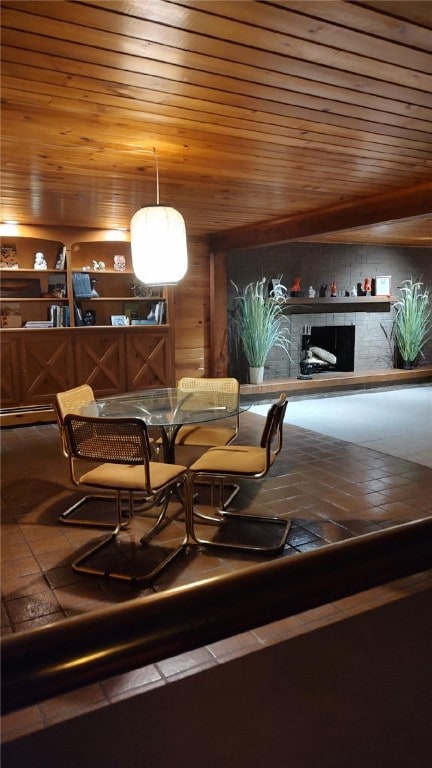 dining area with wood ceiling and a fireplace