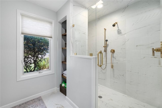 bathroom featuring baseboards, a marble finish shower, and marble finish floor