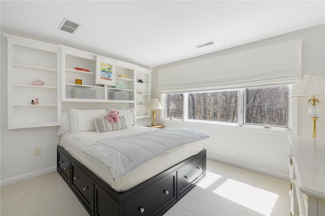 bedroom with light colored carpet, baseboards, and visible vents