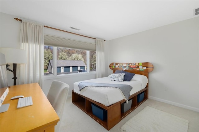 carpeted bedroom featuring baseboards and visible vents