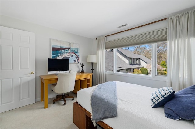carpeted bedroom featuring visible vents and multiple windows