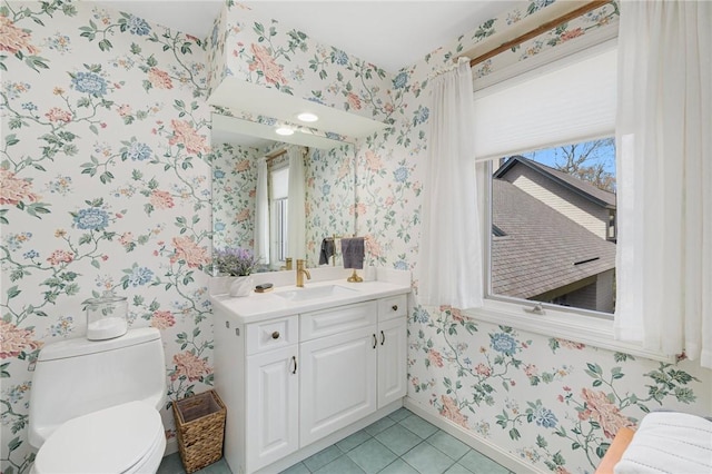 bathroom featuring toilet, wallpapered walls, tile patterned floors, and vanity