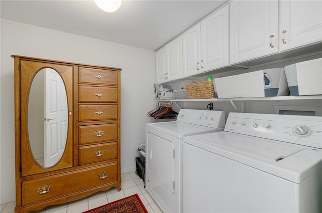 clothes washing area with baseboards, cabinet space, light tile patterned floors, and washing machine and clothes dryer