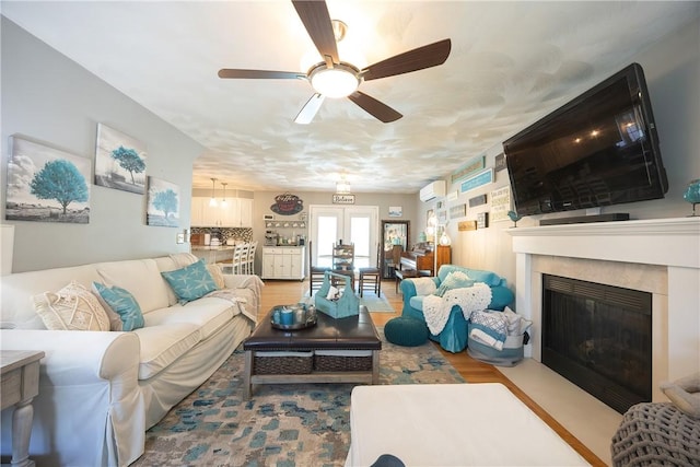 545 Central St, Burrillville, RI 02839 - living room with ceiling fan, a fireplace with flush hearth, a wall mounted air conditioner, and wood finished floors