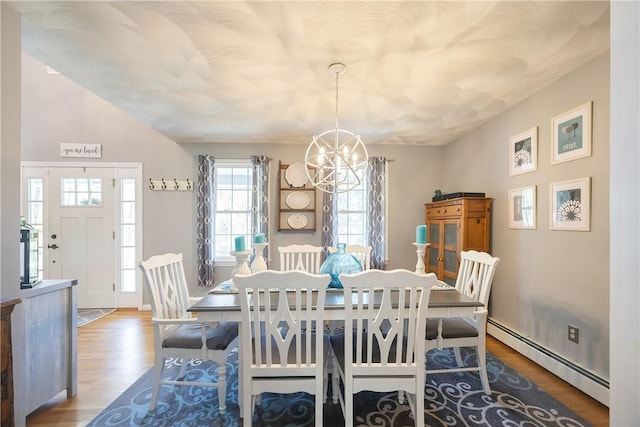 545 Central St, Burrillville, RI 02839 - dining area featuring baseboard heating, a chandelier, and wood finished floors