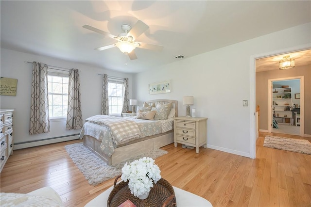 545 Central St, Burrillville, RI 02839 - bedroom with a baseboard heating unit, light wood-type flooring, ceiling fan, and baseboards