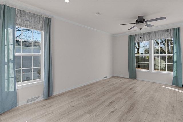 548 Kenyon Ave, Attleboro, MA 02703 - empty room featuring visible vents, plenty of natural light, ceiling fan, and light wood-type flooring