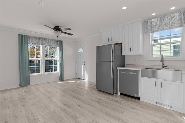 548 Kenyon Ave, Attleboro, MA 02703 - kitchen with crown molding, ceiling fan, appliances with stainless steel finishes, a sink, and visible vents
