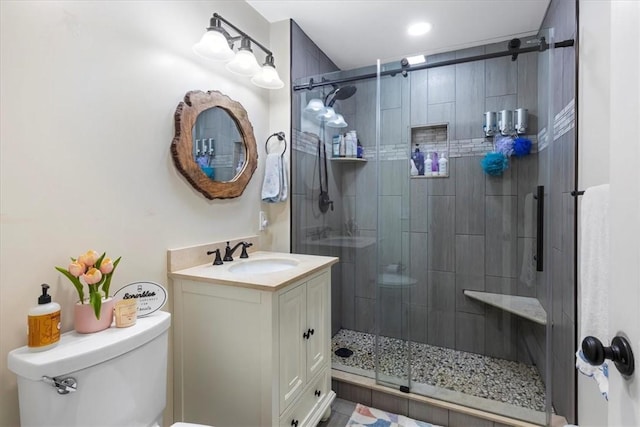 bathroom with toilet, recessed lighting, a shower stall, and vanity
