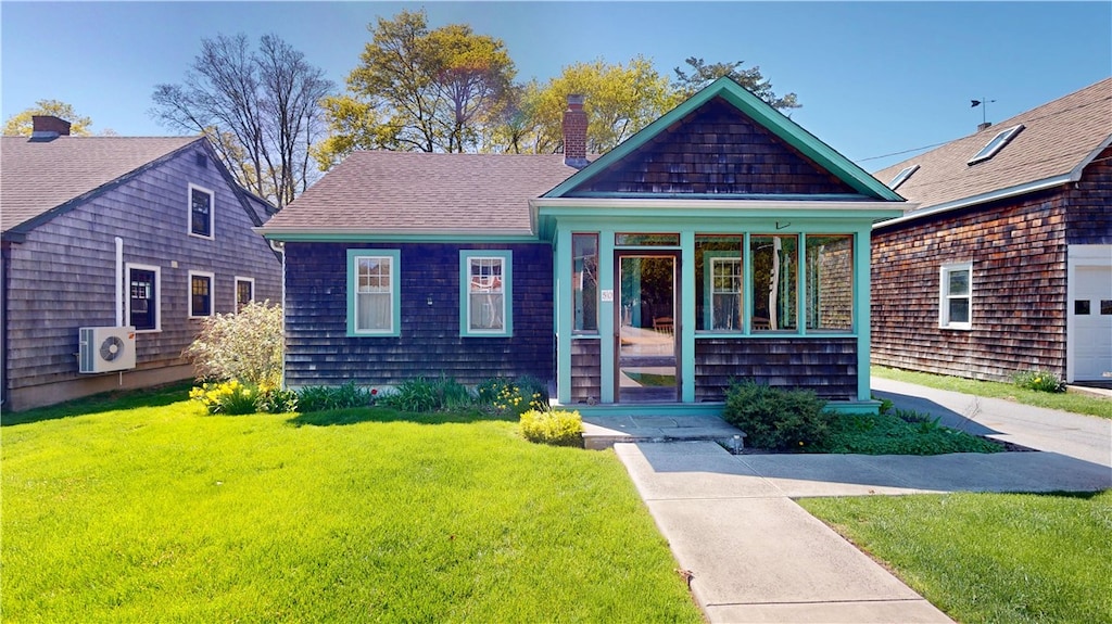 50 Orchard Ave, South Kingstown, RI 02879 - view of front of home featuring a cooling unit, a chimney, a front lawn, and roof with shingles
