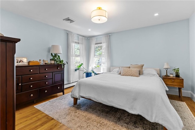 386 Stone Church Rd, Tiverton, RI 02878 - bedroom featuring light wood-type flooring, a baseboard heating unit, and recessed lighting