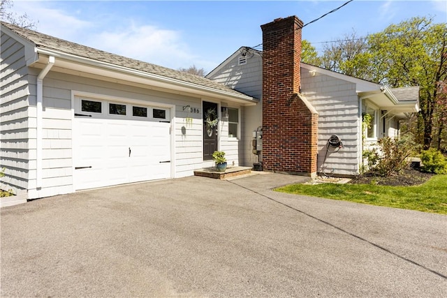 386 Stone Church Rd, Tiverton, RI 02878 - view of front facade featuring an attached garage, a chimney, and driveway