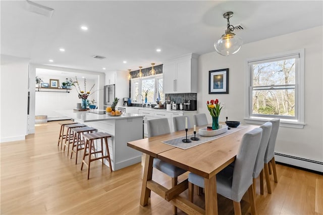 386 Stone Church Rd, Tiverton, RI 02878 - dining room with light wood-style flooring, a baseboard heating unit, and recessed lighting
