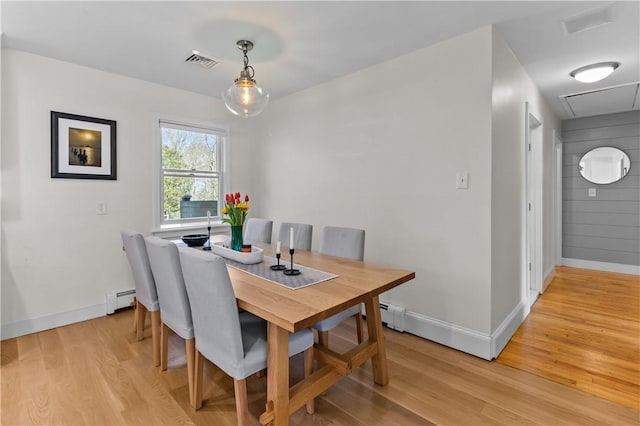 386 Stone Church Rd, Tiverton, RI 02878 - dining room featuring a baseboard heating unit, light wood-style floors, and baseboards